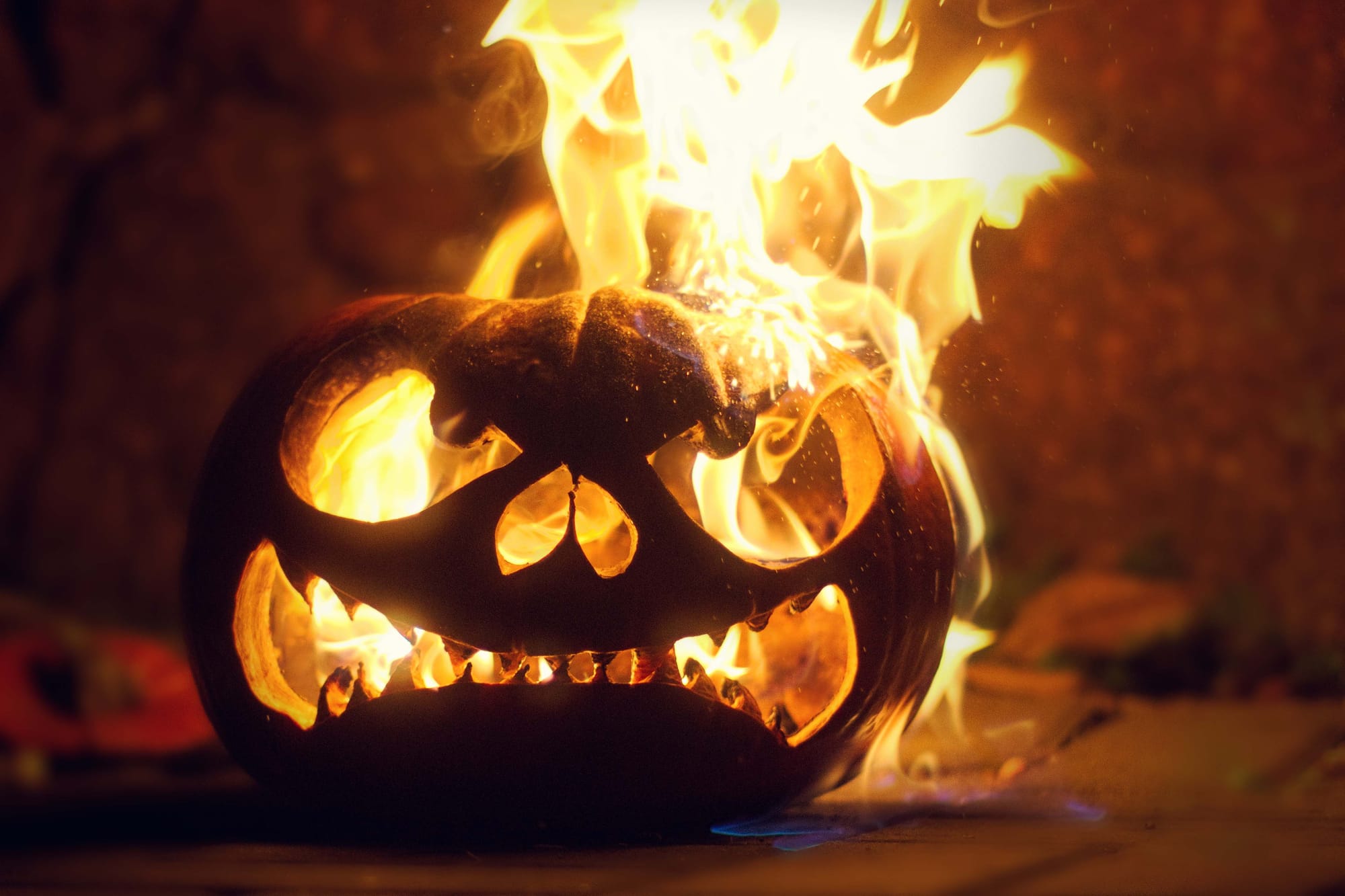 Photo of a carved jack o’ lantern that has been set on fire