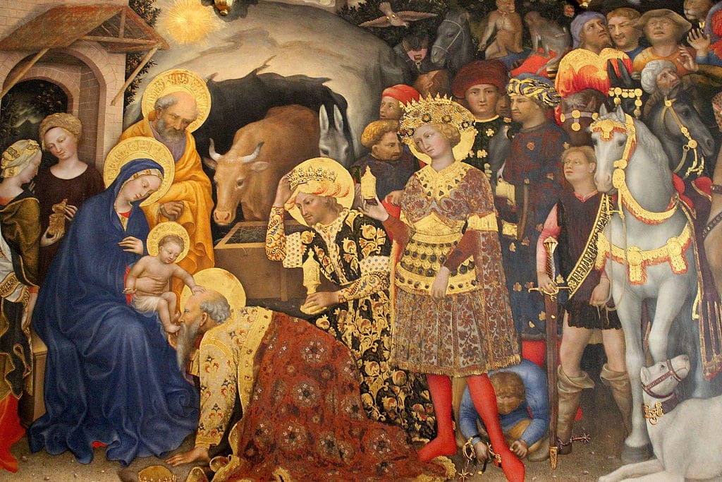 Painting of the three Magi worshipping the infant Jesus, one is kissing his feet, surrounded by people and animals