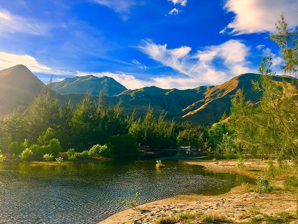 Photo of an isolated cove with mountains in the background