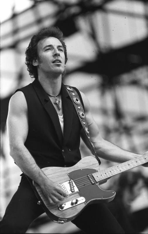 Black-and-white photo of a man playing a guitar