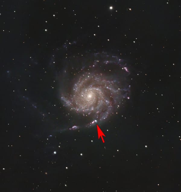 Photo of a spiral galaxy with an arrow superimposed that is pointing to a bright “star”