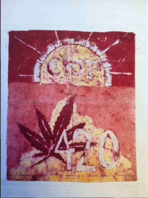 Batik-dyed flag bearing the words “Eyot 420” and a cannabis leaf