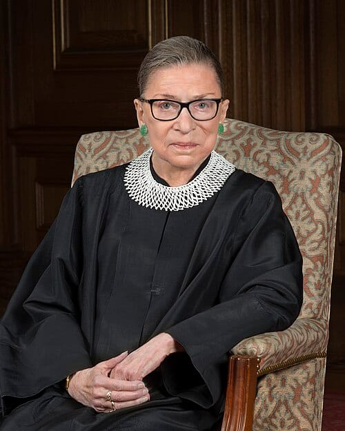Photo of Ruth Bader Ginsberg, in judicial robe, sitting in a chair